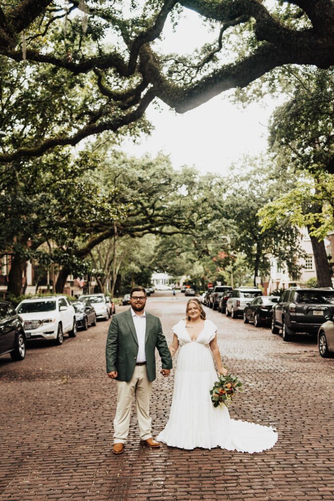 bride and groom under mossy trees in savannah georgia jones street
